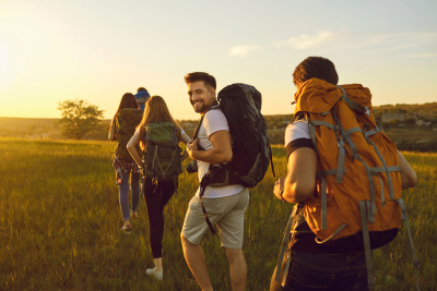 Happy federal employee hiking in the summer sun, planning for the future with federal disability insurance.