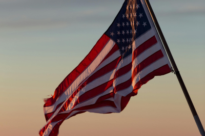 American flag waving at sunset, symbolizing the protection of short term disability for federal employees.