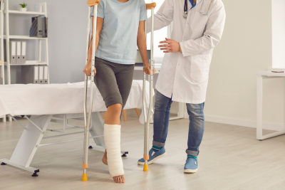 Federal employee on crutches leans on doctor for support, highlighting the need for disability insurance.