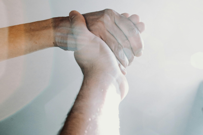 Supportive hands holding each other, symbolizing the security of disability insurance.