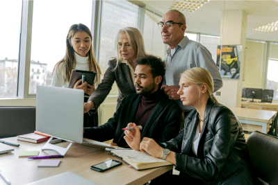 A diverse group of professionals in an office setting, highlighting the importance of disability coverage.