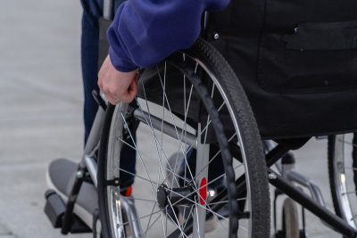 Person using a wheelchair, focusing on working while on federal disability