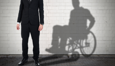 Man's shadow in a wheelchair, symbolizing federal employee disability status.