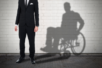 Man's shadow in a wheelchair, symbolizing federal employee disability status.